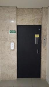 a black door in a room with a wall at Hotel Elo Curitiba in Curitiba