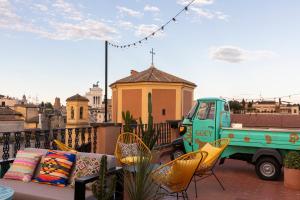 a green truck parked on a balcony with chairs at Chapter Roma in Rome