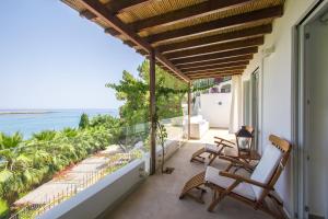 a balcony with chairs and a view of the ocean at Le Calette N.5 in Cefalù