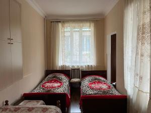 a room with two red chairs and a window at Inexpensive house in Vanadzor