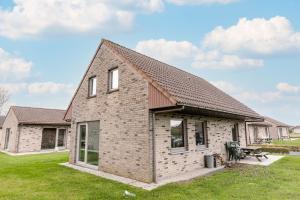 a brick house with a pitched roof at Family Bungalow De Strandjutter 8 people in Middelkerke