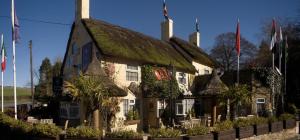 an old building with a grass roof at Crab Manor Hotel in Thirsk