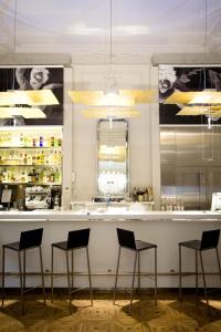a bar in a restaurant with four stools at Hotel C2 in Marseille