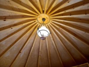 a ceiling with a light in a wooden room at Petromilos1920 in Zefiría