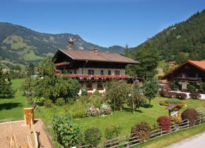 a house with a garden in front of a mountain at Moarbauer in Dorfgastein