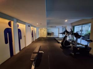 a gym with treadmills and ellipticals in a building at Moon House San Telmo in Buenos Aires