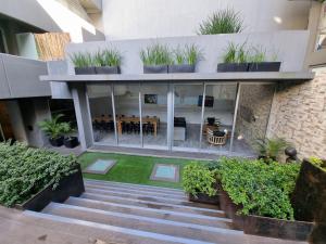 an internal courtyard of a building with potted plants at Moon House San Telmo in Buenos Aires