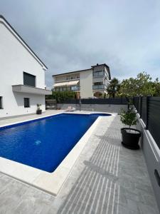 a swimming pool in the backyard of a house at HelaMoni, New 5 Star 2 Person apartments with pool in Malinska