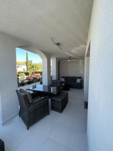 a living room with a couch and a table and chairs at HelaMoni, New 5 Star 2 Person apartments with pool in Malinska