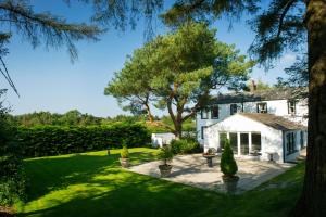 an exterior view of a white house with a garden at Graysonside in Cockermouth