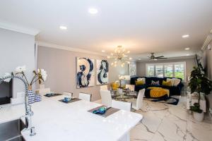 a living room with a couch and a table at Lavish Living ~ Ground Floor Corner Unit in Wesley Chapel