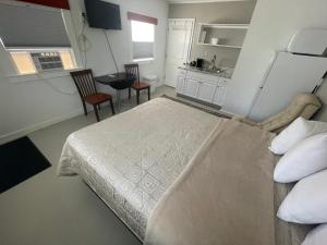 una camera con un grande letto e una cucina di Gallagher’s Travels Bar Harbor Motel and Cottages a Bar Harbor