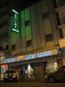 
a large building with a neon sign on the side of it at Hotel Dallas Center in Mar del Plata
