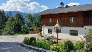 a house with a person on the roof of it at Almhof Grub in Wagrain