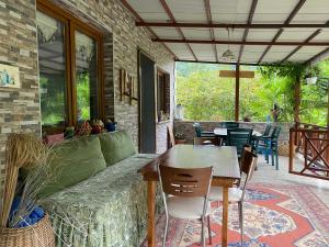 a patio with a couch and a table and chairs at Doğa villa in Yomra