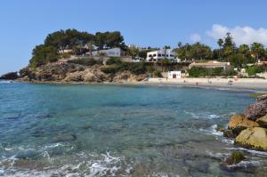 a beach with a group of people in the water at Solhabitat Coll de Mar in Calpe