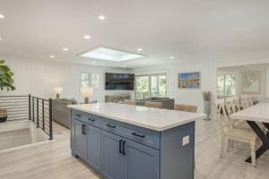 a kitchen and living room with a blue island at Luxury Beach House - 2min Walk to Beach - Private Pool - Group & Dog Friendly in Hilton Head Island