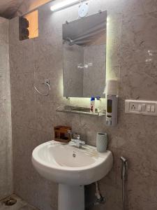 a bathroom with a white sink and a mirror at H2H Bir l Nature Camps in Bīr +64 photos