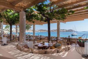 a restaurant with a view of the ocean at Bill & Coo Mykonos -The Leading Hotels of the World in Mýkonos City