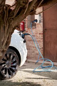 a car with a hose hooked up to a tree at Marchesi Incisa Winery Lodge in Rocchetta Tanaro