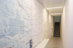a mural of a building on a wall in a hallway at N Apartments - Chã in Porto