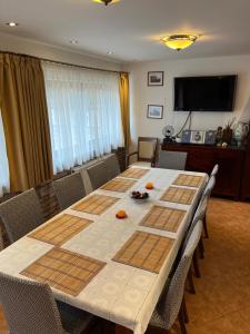 a dining room table with chairs and a television at Holiday Home Siraly in Miskolctapolca