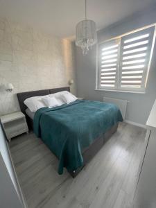 Uma cama ou camas num quarto em Apartament Łęczycka