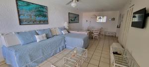 a living room with a blue couch and a table at Sapphire Village Condos in Nazareth