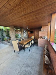 a dining room with a wooden table and chairs at Ortachala Veranda in Tbilisi City