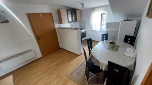 a kitchen and a dining room with a table and chairs at Apartma ASJA in Brežice