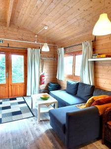 a living room with a couch and a table at Ásgeirsstaðir Holiday Homes in Ásgeirsstaðir