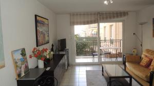 a living room with a couch and a table at ACCI le Palazzio in Cannes