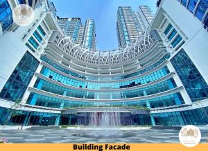a large building with a fountain in front of it at Pacific Home Petaling Jaya by Seven Sins in Petaling Jaya