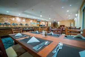 a dining room with a wooden table with napkins and silverware at Blumar El Dome Hotel in Ain Sokhna