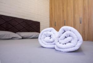 a couple of towels on a bed at Urban place apartment Žabljak in Žabljak