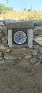 a stone wall with a plate on top of it at Theros house in Kythira