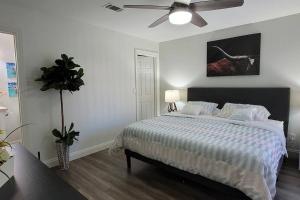 a white bedroom with a bed and a ceiling fan at L - Fully remodeled and professionally decorated in Las Vegas