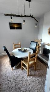 a dining room with a white table and chairs at Dune Cottage in Caister-on-Sea
