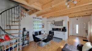 a kitchen and living room with a table and chairs at Ferienhaus Ranzer in Spielberg