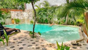 uma pessoa está nadando em uma piscina em Niik Tulum em Tulum