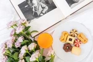 a plate of food with a salad and orange juice at Living Place Hotel in Villanova