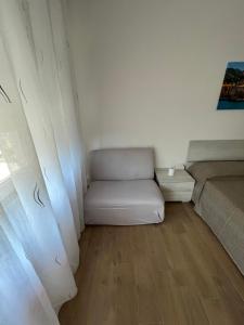 a small room with a bed and a couch at La casa di Maria in Rapallo