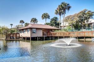 a house with a fountain in the middle of a lake at Walk to Beach-Forest Ridge 2747-Pool,Tennis,Pickleball,Playground-Nestled Amongst the Oaks in Fernandina Beach