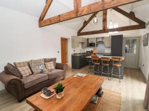 a living room with a couch and a table at The Cow Shed at Pear Tree Farm in Doncaster