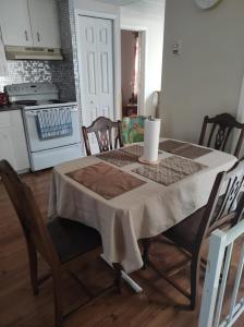 a table with a table cloth on it in a kitchen at Private Home in downtown Edmundston! in Edmundston