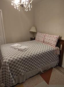 a bedroom with a bed with two towels on it at Private Home in downtown Edmundston! in Edmundston