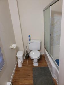 a bathroom with a toilet and a glass shower at Private Home in downtown Edmundston! in Edmundston
