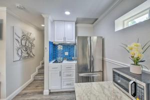 a kitchen with white cabinets and a stainless steel refrigerator at Cute Central Placerville Studio Pet Friendly in Placerville