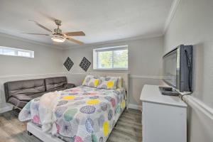 a bedroom with a bed and a flat screen tv at Cute Central Placerville Studio Pet Friendly in Placerville