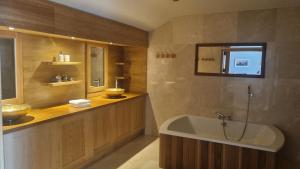 a bathroom with a bath tub and a sink at Fab View in Dingle